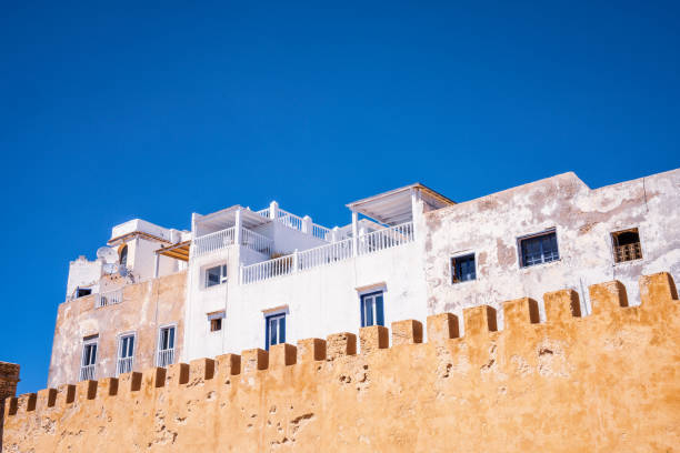 A row of apartment buildings rising above the level of Essaouira's external city walls.