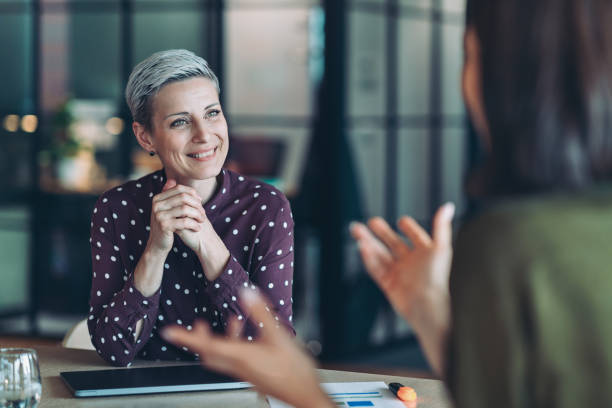 istock Focus on a smiling female entrepreneur during a meeting 2155904824