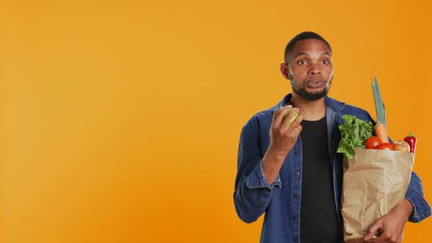istock Confident man juggling with an eco friendly green apple on camera 2155904992