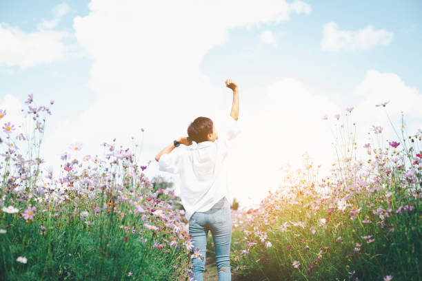 istock Young woman on field under sunset light 2155907756
