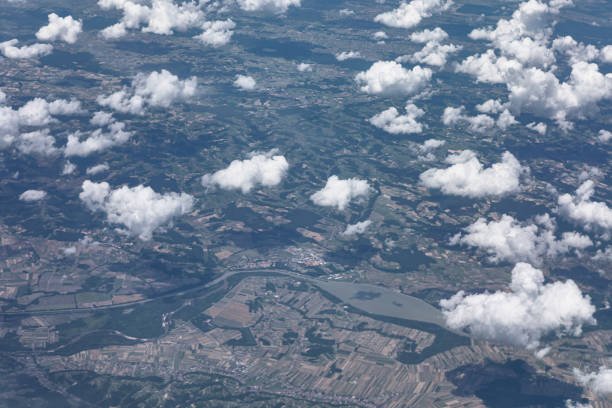Aerial perspective of fluffy clouds from an airplane. Tranquil view of clouds over the Earth