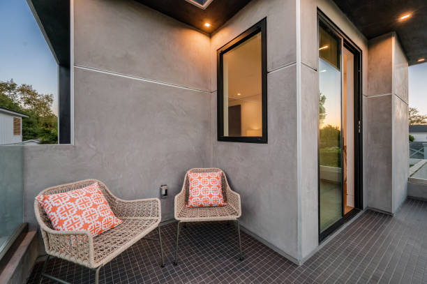 istock a balcony with wicker chairs on it and large windows 2155908196