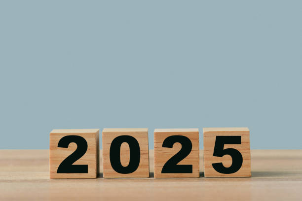 istock 2025, Numbers on wood blocks. On blue background, new year concept. 2155909047