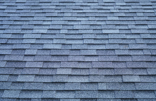 istock close up on new installed roof shingle 2155911710