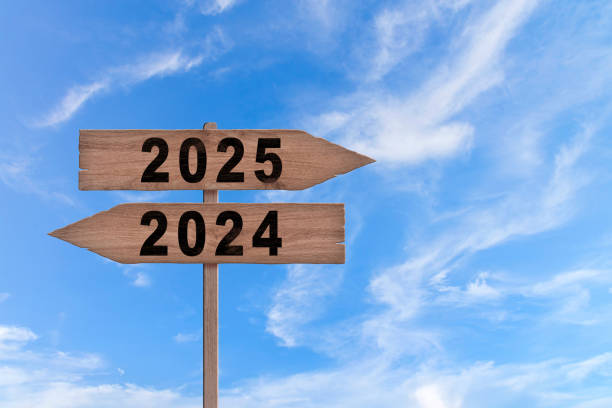 istock An image with a signpost pointing in two different directions in German. One direction points to 2024, the other points to 2025. 2155913340