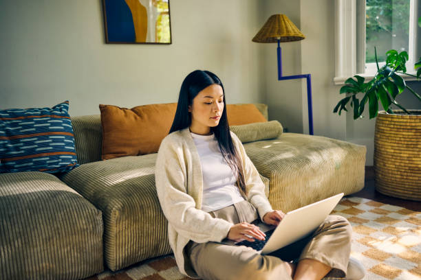 istock Young Asian self-employed female working from home. Remote work and productivity concept. 2155915931