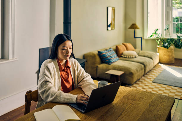 istock Young Asian self-employed female working from home. Remote work and productivity concept. 2155915960