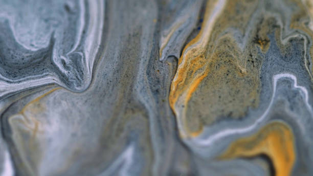 istock Glitter fluid flow paint mix wave gray golden ink 2155916996