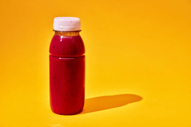 Berry Smoothie in Recycled PET Plastic Bottle on Yellow Background