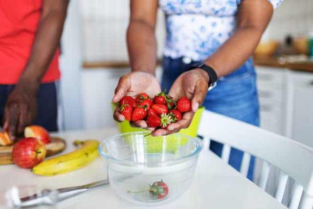 istock Closeup of hands with strawberry 2155922376