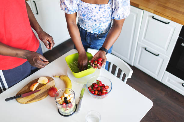 istock Young black couple cooking smoothie at the kitchen 2155922657