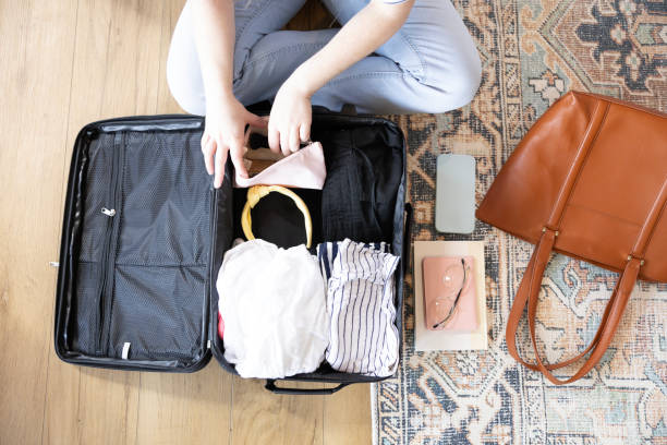 istock Overhead view unrecognizable woman checking suitcase contents 2155928016