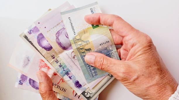 istock paper money and human hand 2155928468