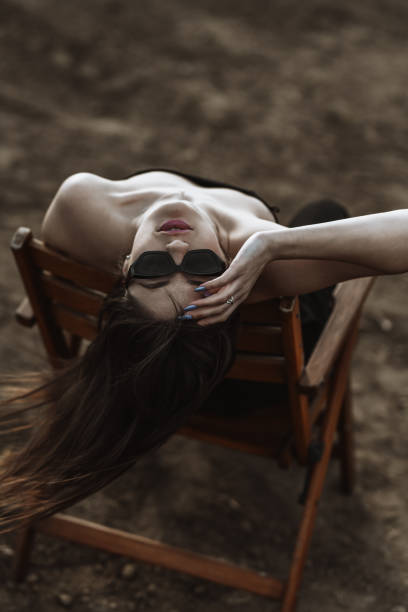 Beautiful Female Staring Upside Down From A Chair