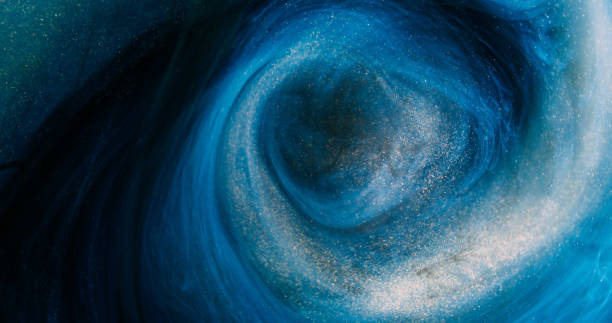 Glitter mist ink swirl blue golden particles paint