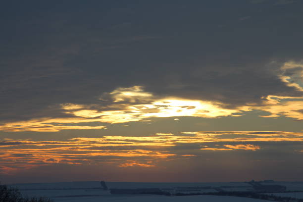 A sunset over a body of water. Sky. Outdoor. Sunset. Sun. Clouds