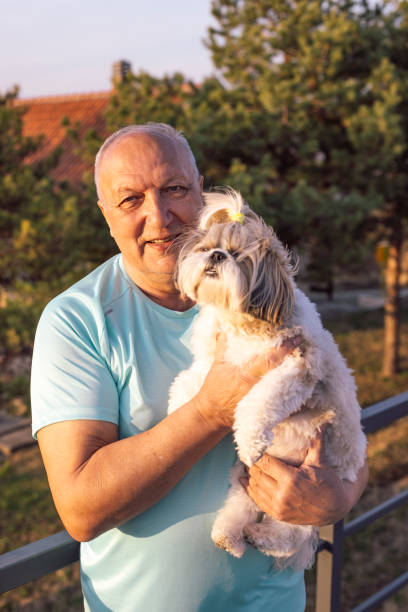 istock Senior Man Holding His Favourite Dog 2155936623