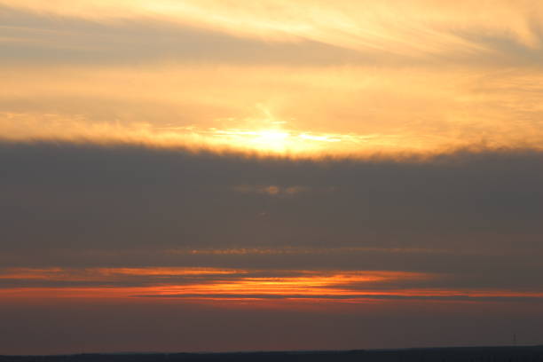 A sunset over a body of water. Outdoor. Sunset. Sky. Sun. Nature
