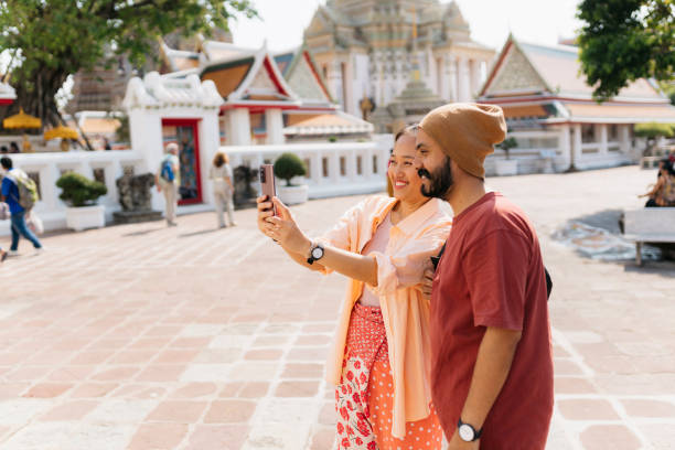 istock Happy diverse couple taking selfies at historic site during vacation 2155944383