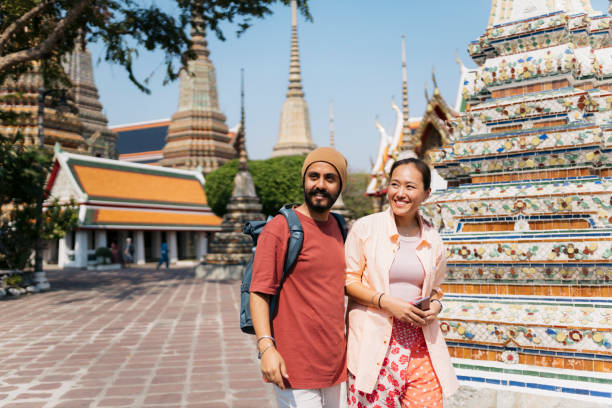 istock Happy tourist couple visiting a Thai temple 2155945088
