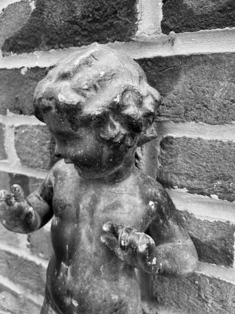 Italy: Celano, Abruzzo. Detail of a cherub sculpture on the 15th century portal of San Francesco, the romanesque church built at Celano, in Abruzzo, to celebrate the visit of Saint Francis (1300 circa).