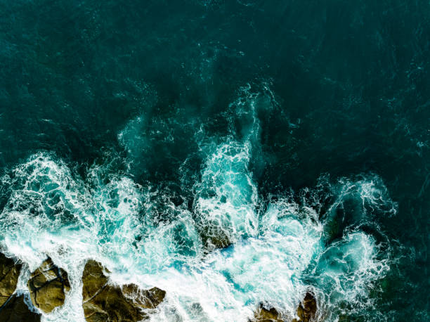 istock Bird eye view seashore with big wave crashing on rock cliff. Beautiful waves sea surface in sunny day summer background, Amazing seascape top view seacoast landscape view 2155948873