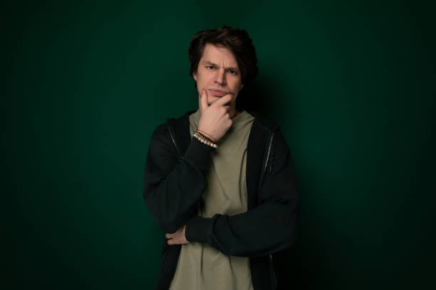 istock Man Standing in Front of Green Wall 2155949377