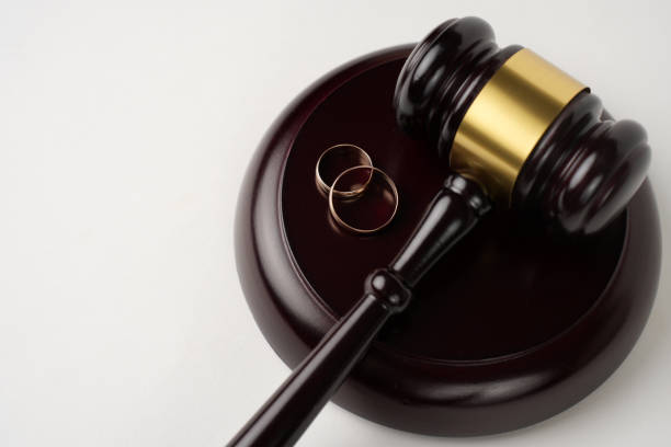 istock Judge gavel and Wedding rings on white background with copy space, close-up. 2155951468
