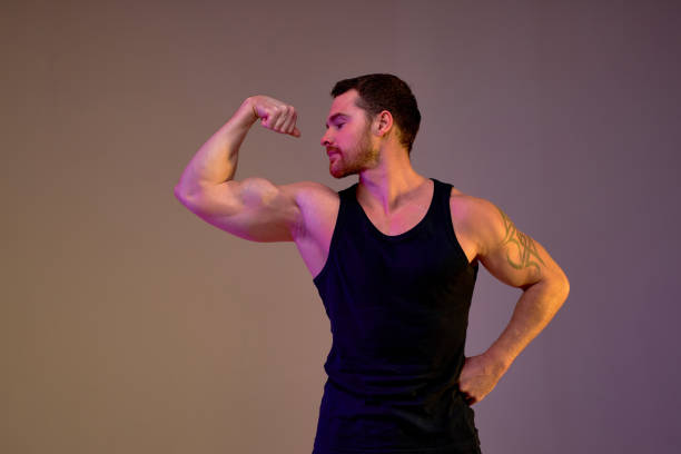 istock Muscular motivated ambitious young man shows his strength 2155953748