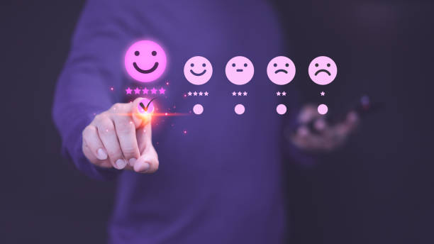 istock Customer hand touch the virtual screen on happy smile face icon to give satisfaction in service. Business concept of assessment testimonial customer service and feedback, Opinion rating very good. 2155954354