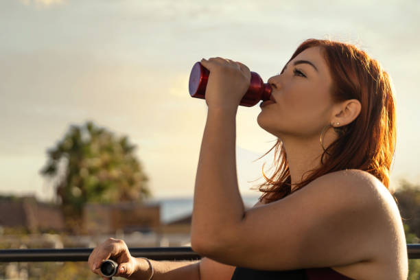 istock Active Woman Hydrating with Juice After Workout 2155955408