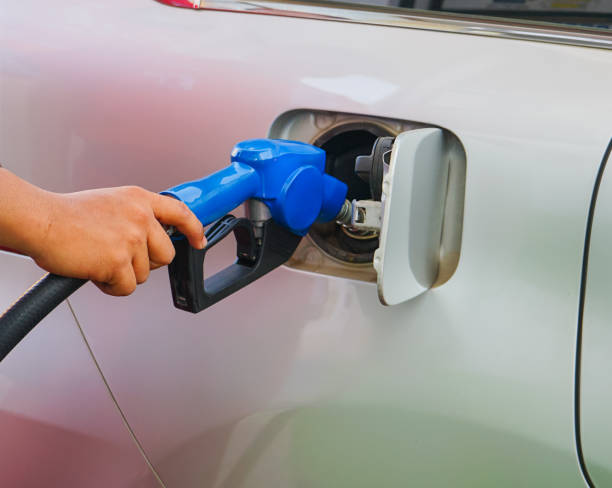istock Hand holding the nozzle and refueling the car 2155955965
