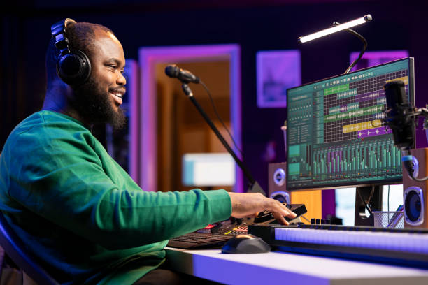 istock Sound engineer working with mixing console and synthesizer to edit audio files 2155965120