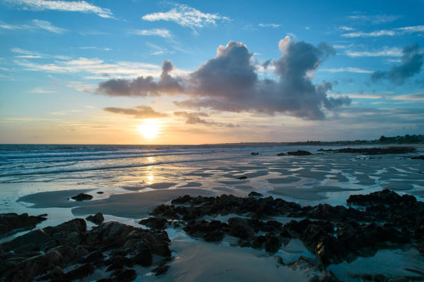 Sunset at the beach. Stones in the foreground. Sky for Copy space.