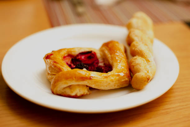 Pastry on a plate and on a wooden table