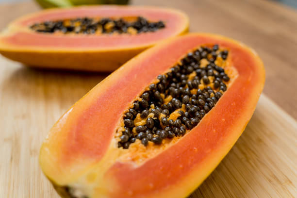 istock Chef cuts and peels papaya on the cutting board 2155968786