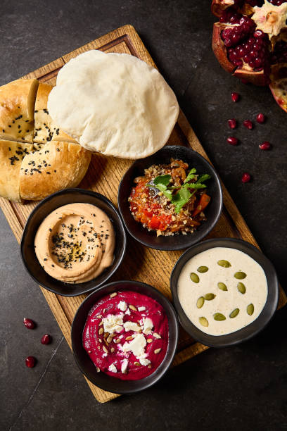 istock Middle Eastern Mezze Platter with Assorted Dips: Hummus, Beetroot Hummus, Ajapsandali, Tonnato Sauce, Pita, and Flatbread 2155972106
