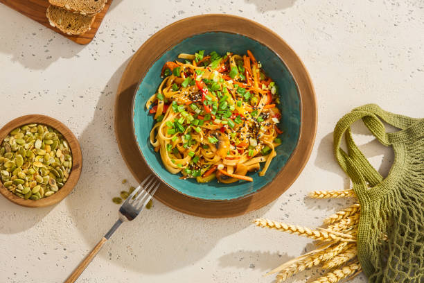 istock Vegetarian Udon Noodles with Vegetables and Sesame Seeds 2155972144