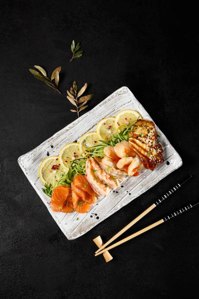 istock Diverse Sashimi Platter on Dark Background, Featuring Salmon, Shrimp, Scallop, and Eel 2155972162