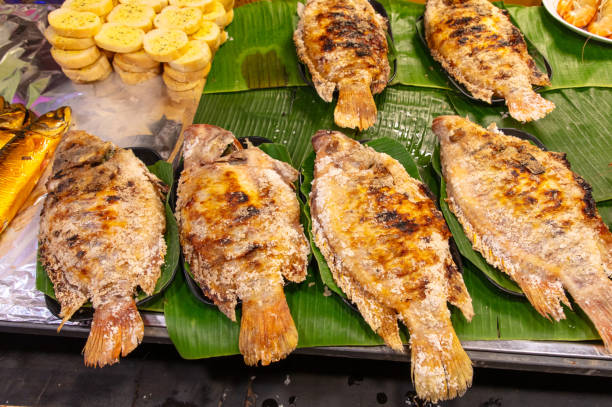 istock Crucian fish fried on coals on a grill 2155973218