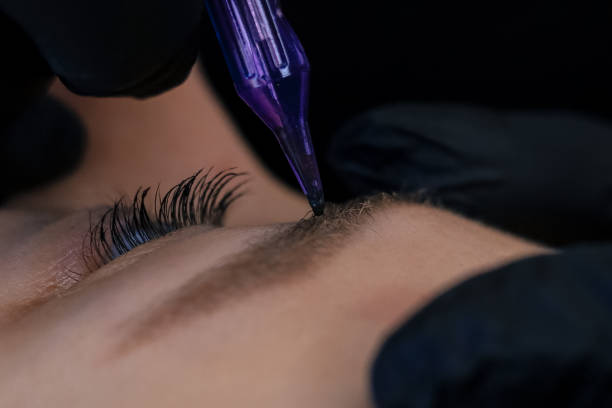 istock procedure of permanent makeup in tattoo salon 2155974549