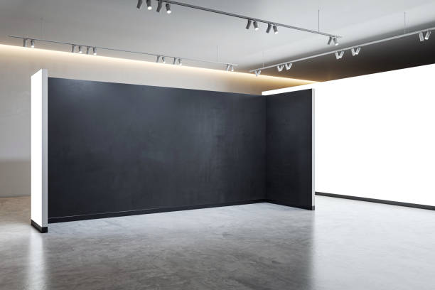 istock An empty modern interior with blank exhibition walls, illuminated by track lighting, set against a gray backdrop, concept of a gallery space. 3D Rendering 2155975674