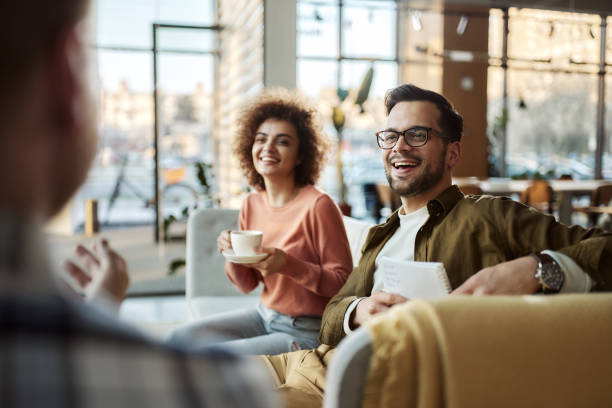 istock Young happy friends talking on sofa in corridor. 2155977644
