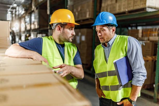 istock Manager giving instructions to his worker in distribution warehouse. 2155978862