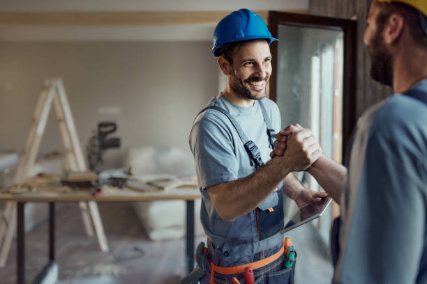 istock Happy manual workers greeting with manly handshake during home renovation process. 2155979670