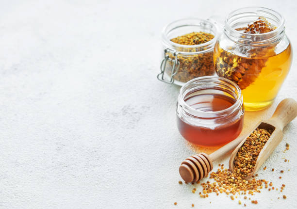 istock Raw organic bee pollen and honey in jars. 2155979842