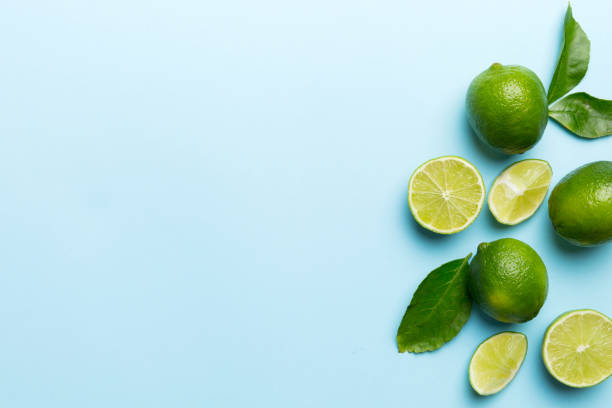 istock Lime fruits with green leaf and cut in half slice isolated on white background. Top view. Flat lay with copy space 2155980650