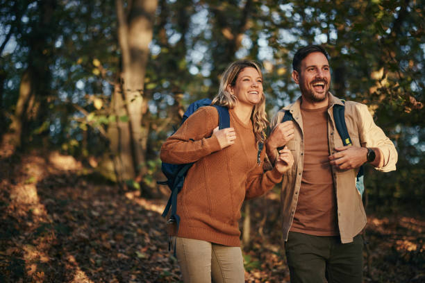 istock Happy couple enjoying while hiking though the woods. 2155981489
