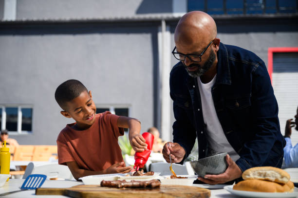 istock A father and son spread tomato sauce on boerewors 2155981633
