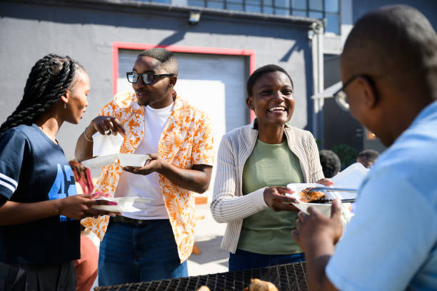 istock A chef serves grilled meat to a smiling black female student 2155981725